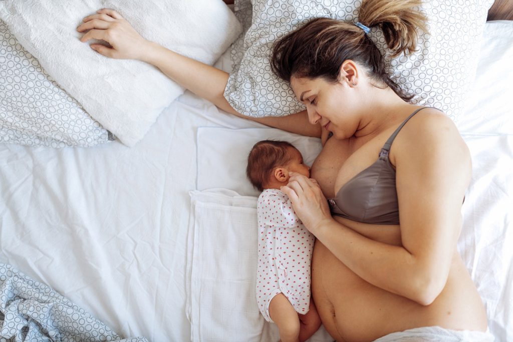 Postpartum Mother Breastfeeding her newborn baby